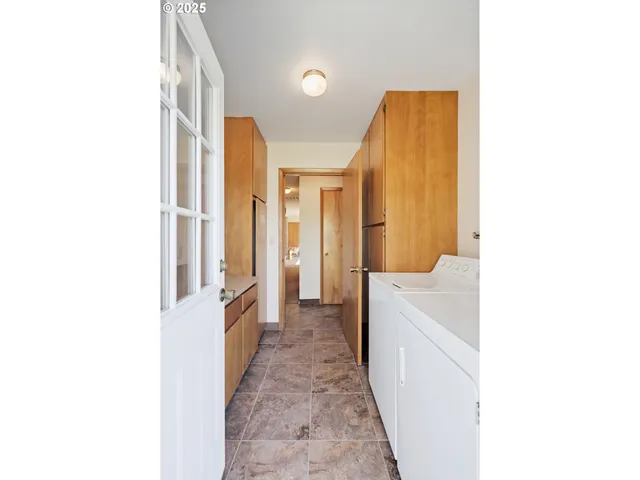 a hallway with a sink and a refrigerator