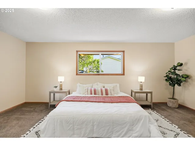 a bedroom with a bed and a potted plant