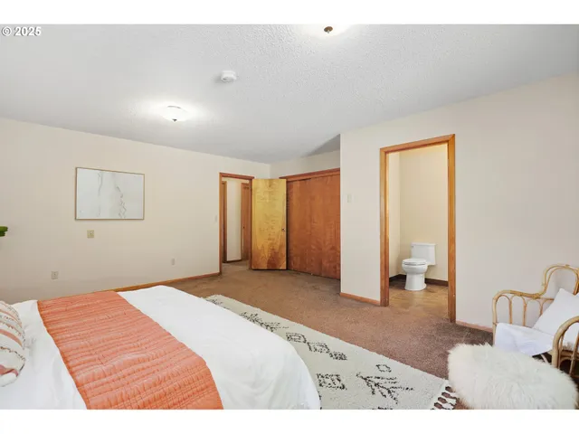 a bedroom with a bed and a couch