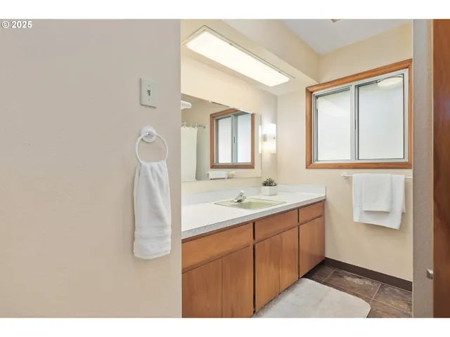 a bathroom with a sink a mirror and a vanity