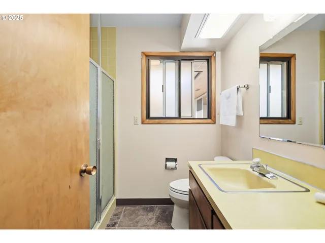 a bathroom with a sink a toilet and a mirror