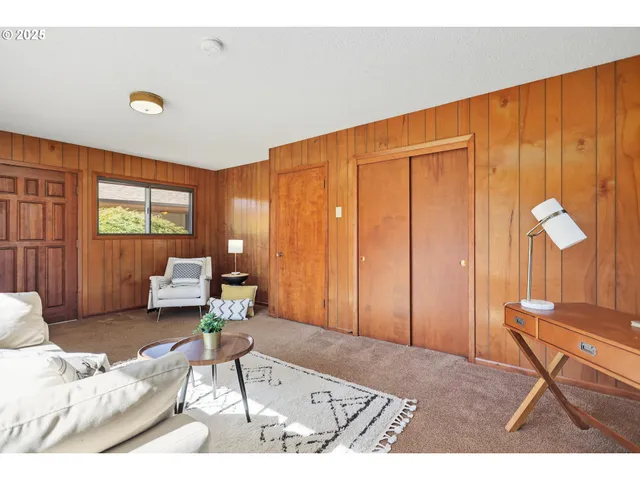 a living room with furniture a lamp and a window