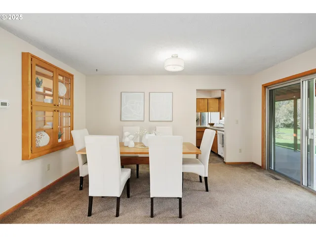 a view of a dining room with furniture and a window