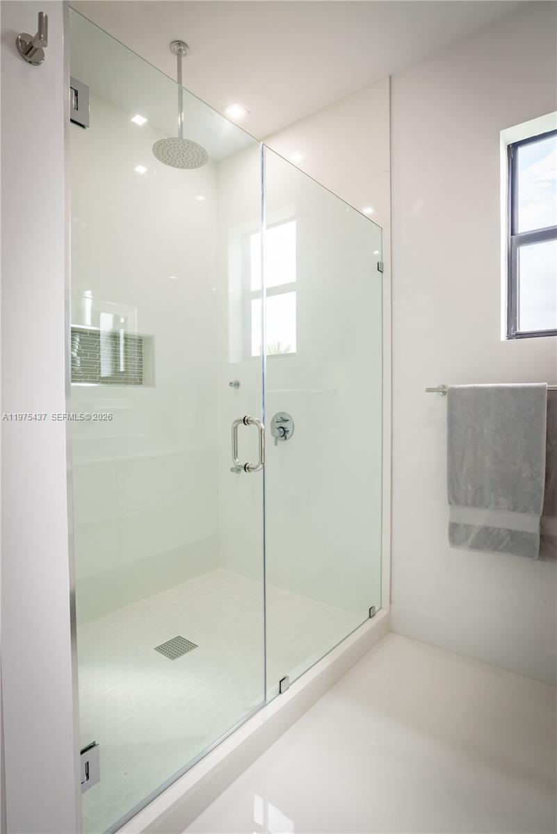 3107 Southwest 26th Street, Unit 3107 Miami, FL 33133 - Photo 15 of 26 a bathroom with a shower and a glass door