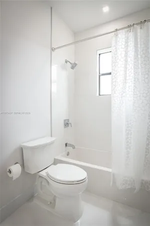 a bathroom with a toilet a sink and shower