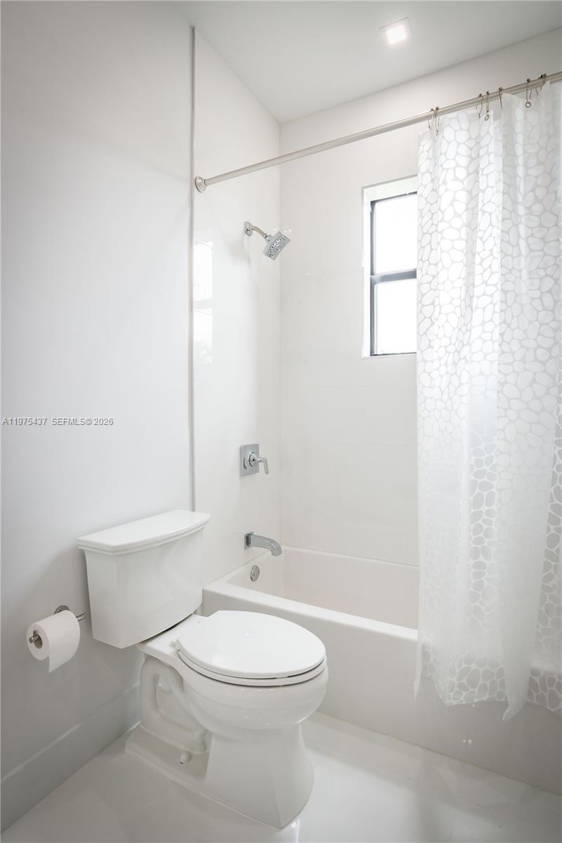3107 Southwest 26th Street, Unit 3107 Miami, FL 33133 - Photo 20 of 26 a bathroom with a toilet a sink and shower