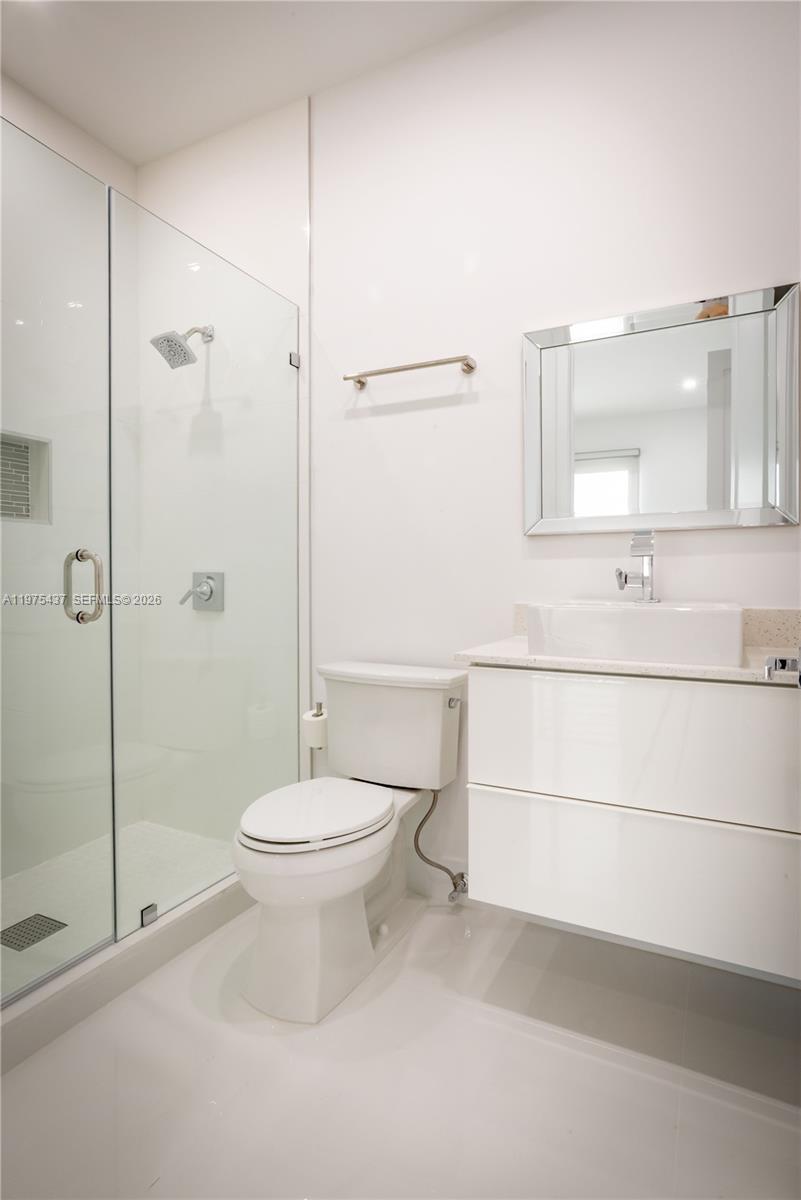 3107 Southwest 26th Street, Unit 3107 Miami, FL 33133 - Photo 25 of 26 a bathroom with a toilet a sink and shower