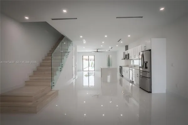 a view of kitchen with refrigerator and window