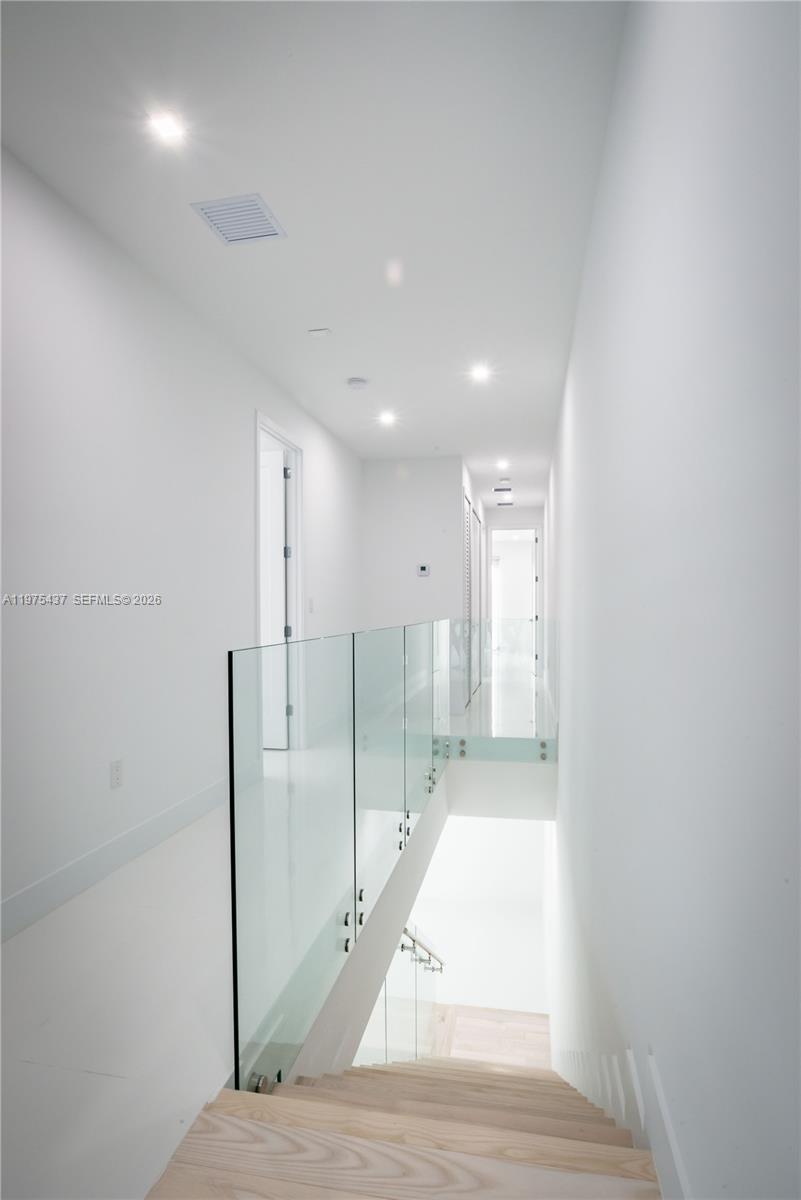 3107 Southwest 26th Street, Unit 3107 Miami, FL 33133 - Photo 8 of 26 a view of a hallway with wooden floor