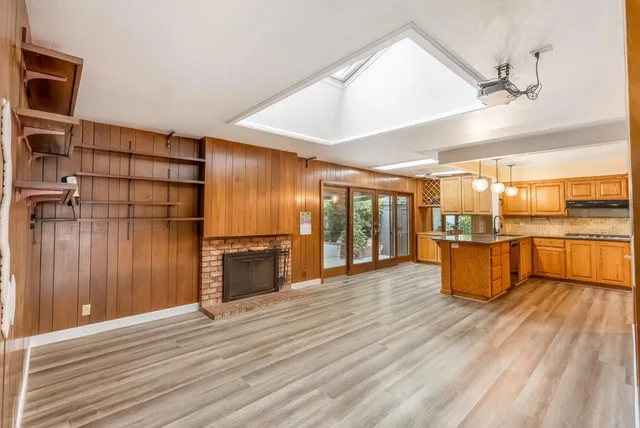a view of a hallway with wooden floor and cabinet