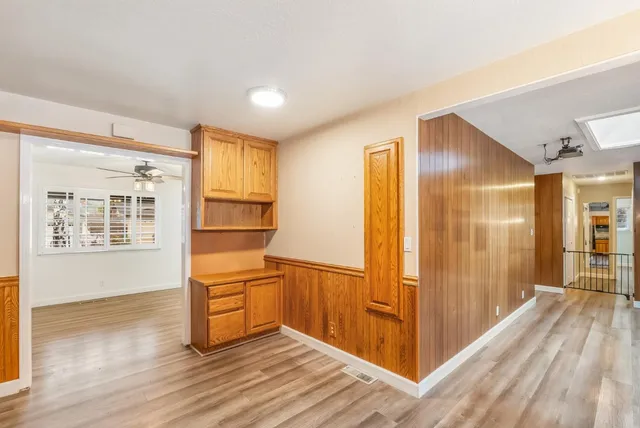 a view of an empty room and wooden floor