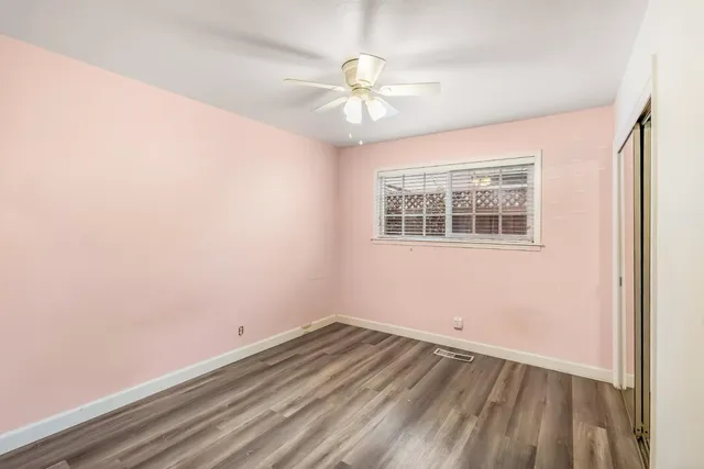 a bathroom with a granite countertop sink a mirror and a shower