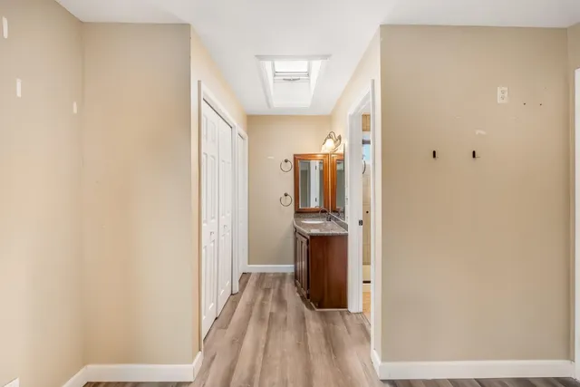 a en suite bathroom with a granite countertop sink and a mirror