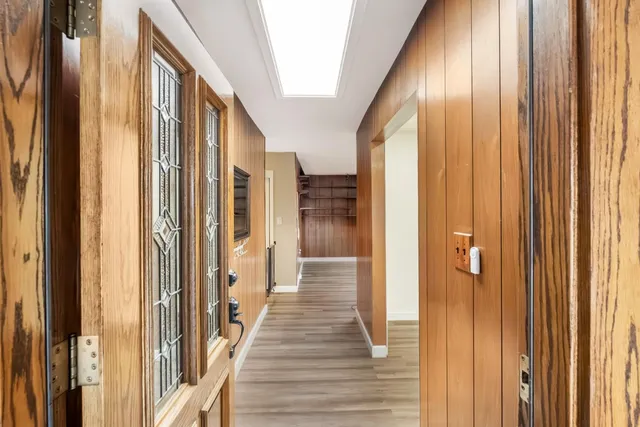 a view of a hallway with wooden floor and staircase