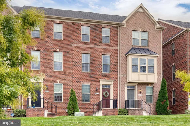 front view of a brick house with a yard