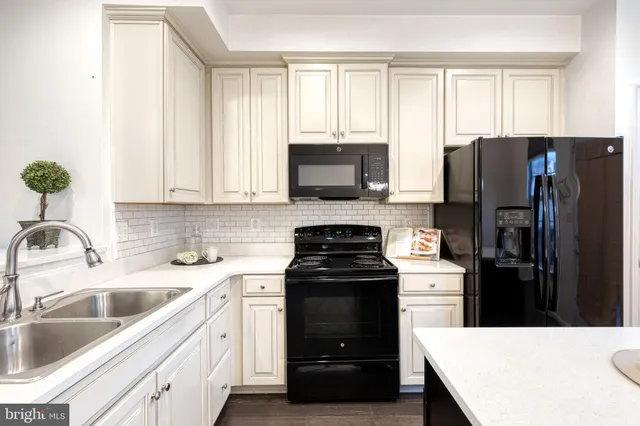 a kitchen with a sink stove and refrigerator