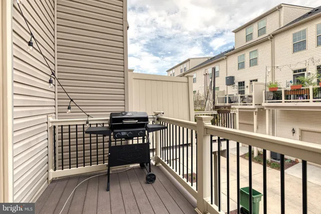 a view of a balcony with two chairs and wooden floor