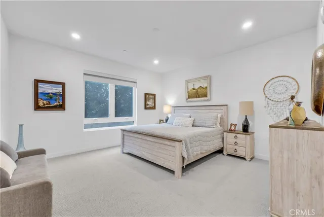 a spacious bedroom with a bed and window