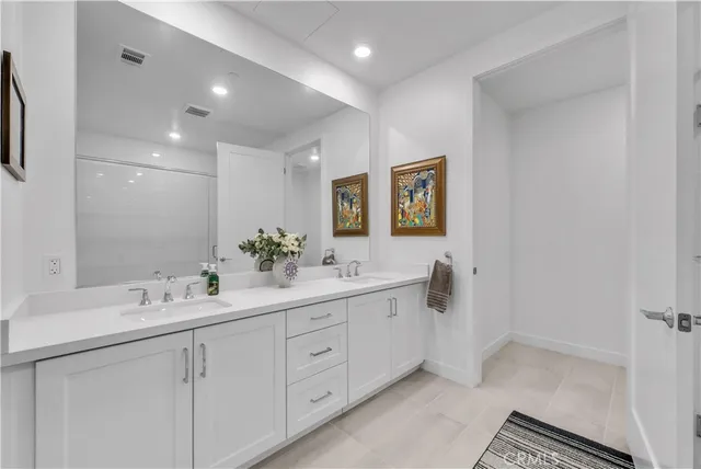 a bathroom with a double vanity sink and mirror