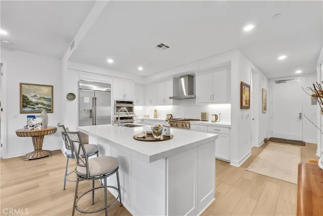 a kitchen with stainless steel appliances kitchen island granite countertop a sink and cabinets