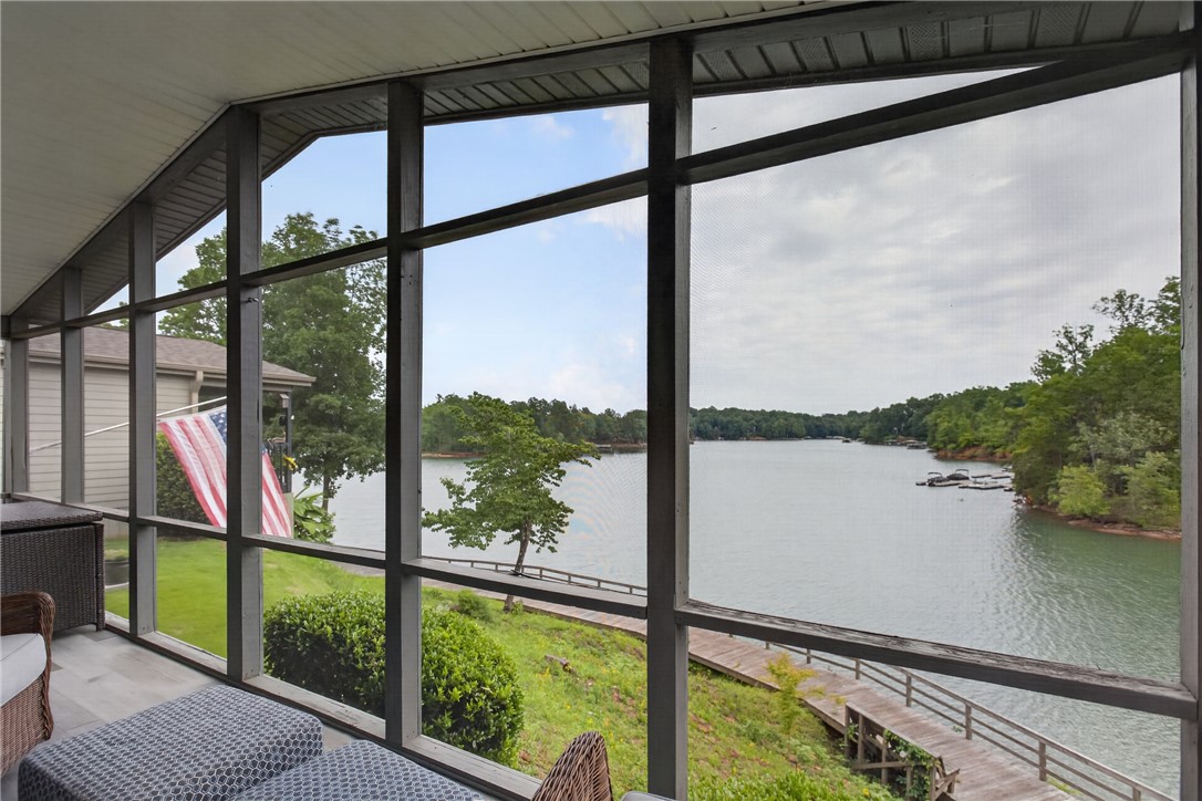 1230 Melton Road, Unit 4 West Union, SC 29696 - Photo 29 of 48 A tranquil lake view from a screened porch with a wooden walkway to the water.