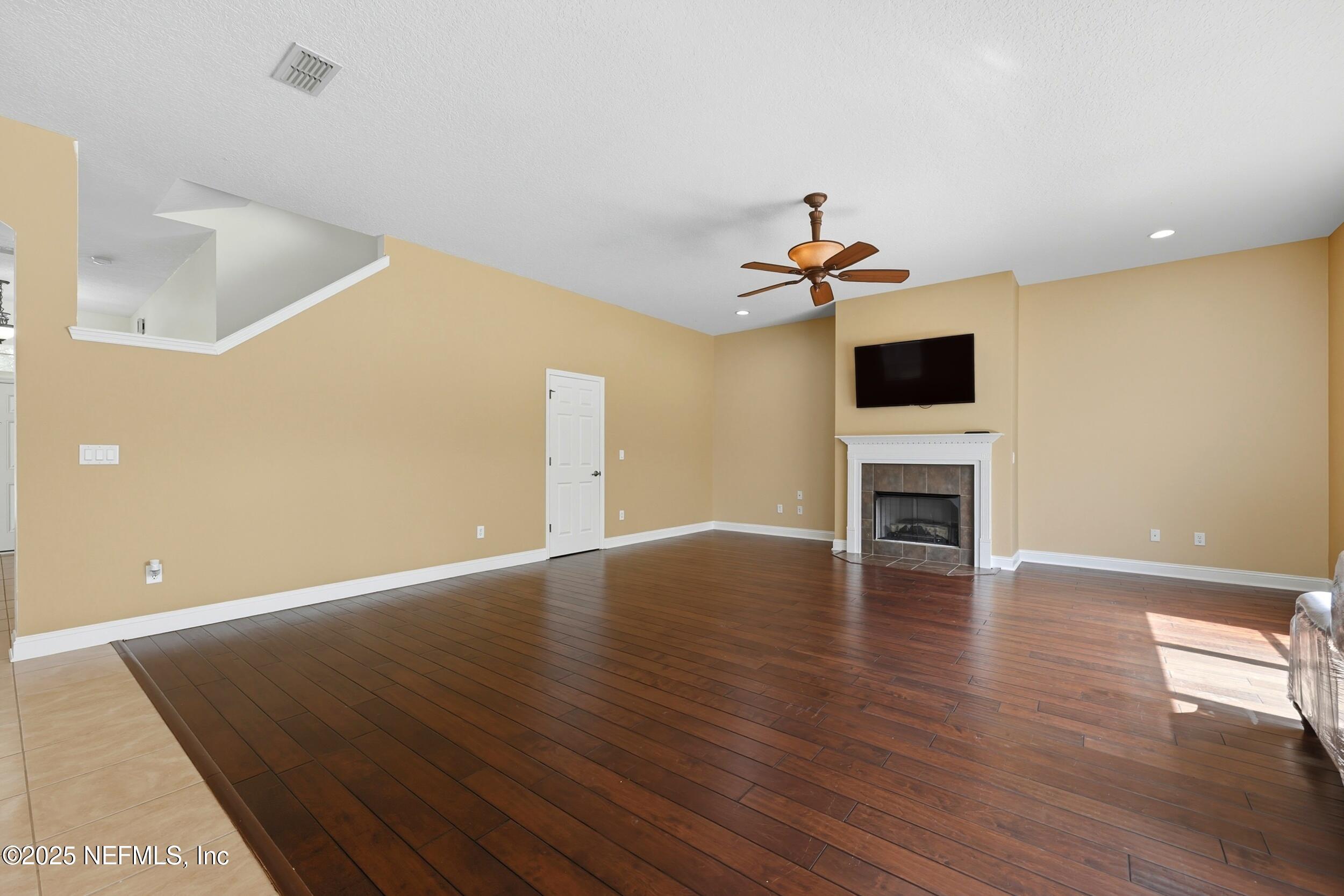 105 Castlegate Lane St. Johns, FL 32259 - Photo 15 of 45 a view of empty room with wooden floor and a ceiling fan