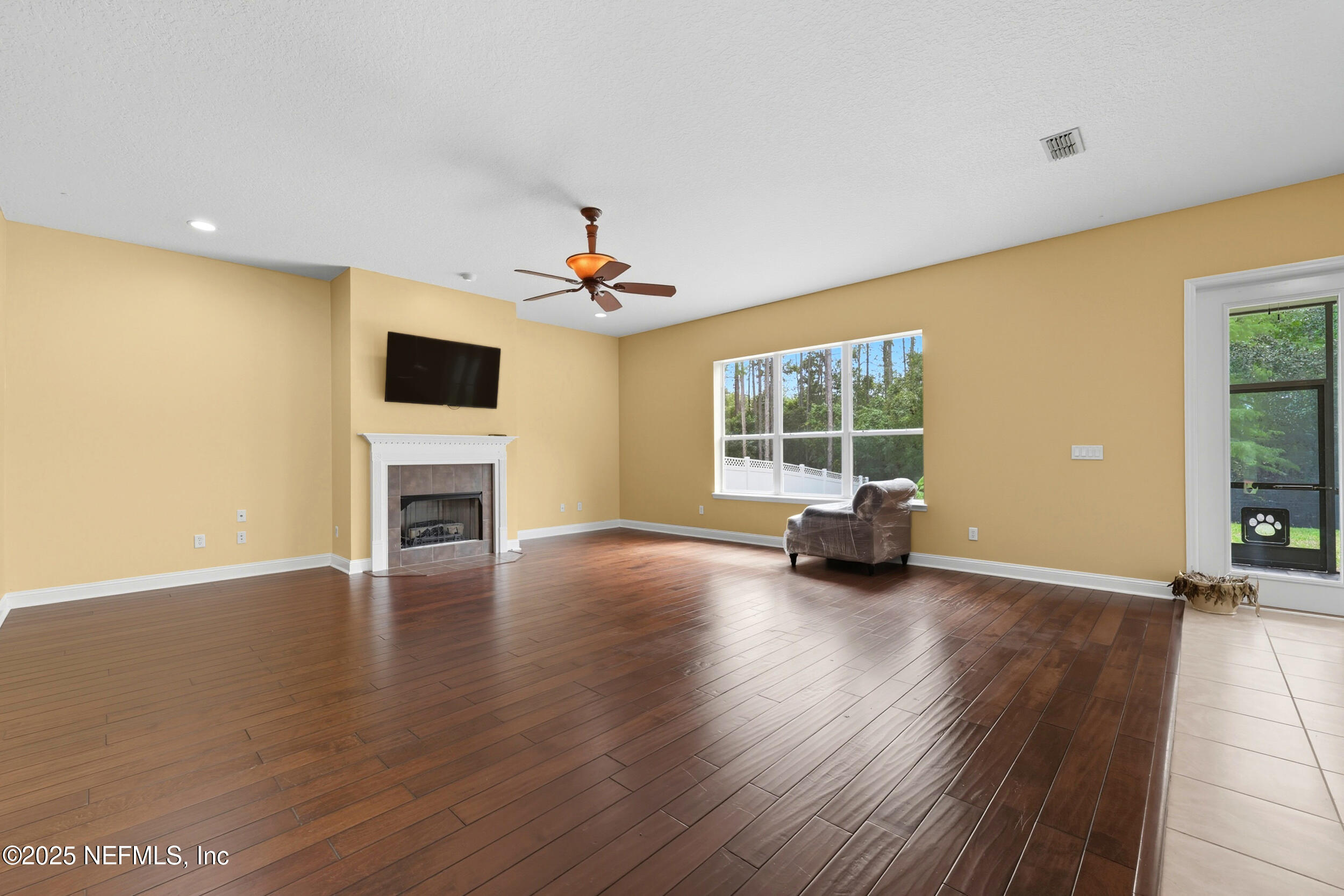 105 Castlegate Lane St. Johns, FL 32259 - Photo 18 of 45 a view of an empty room with wooden floor and a window