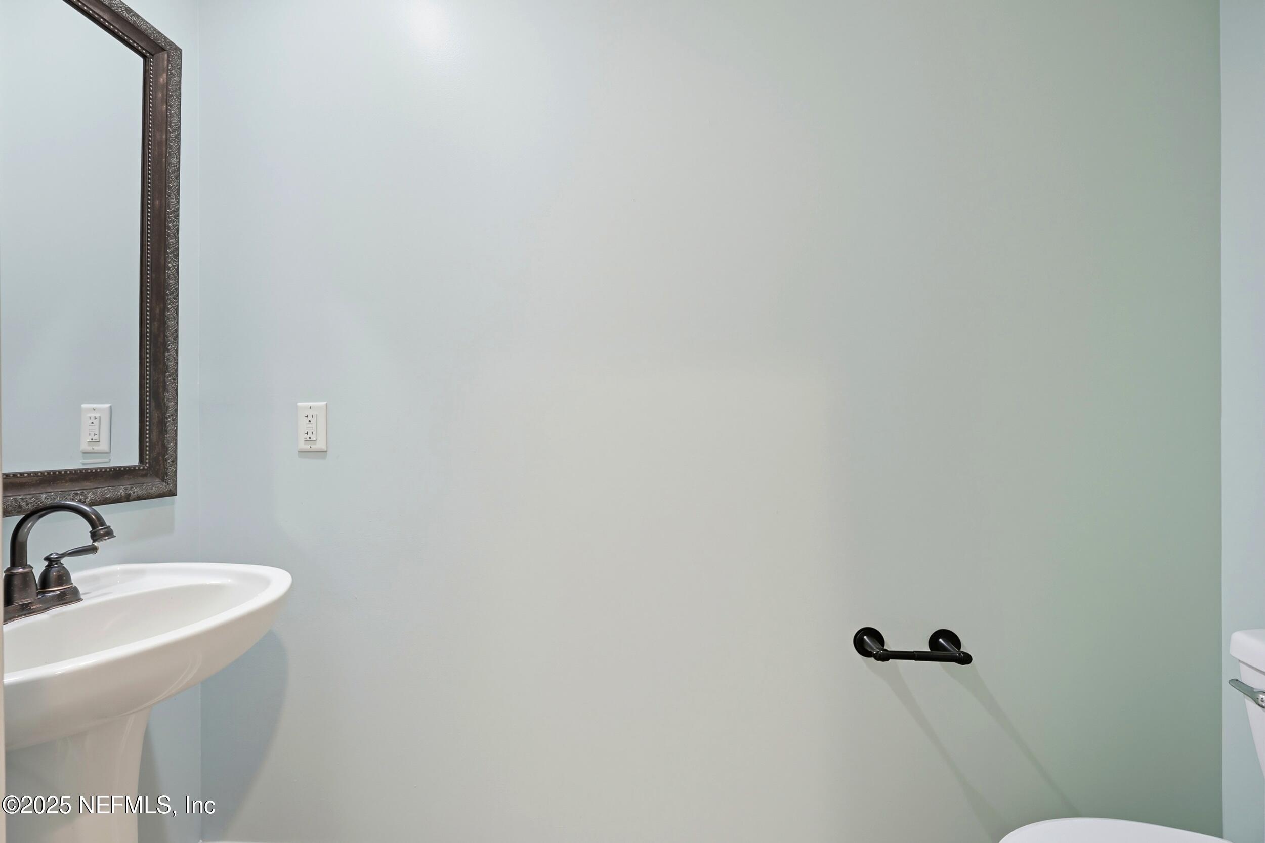 105 Castlegate Lane St. Johns, FL 32259 - Photo 19 of 45 a bathroom with a sink and mirror