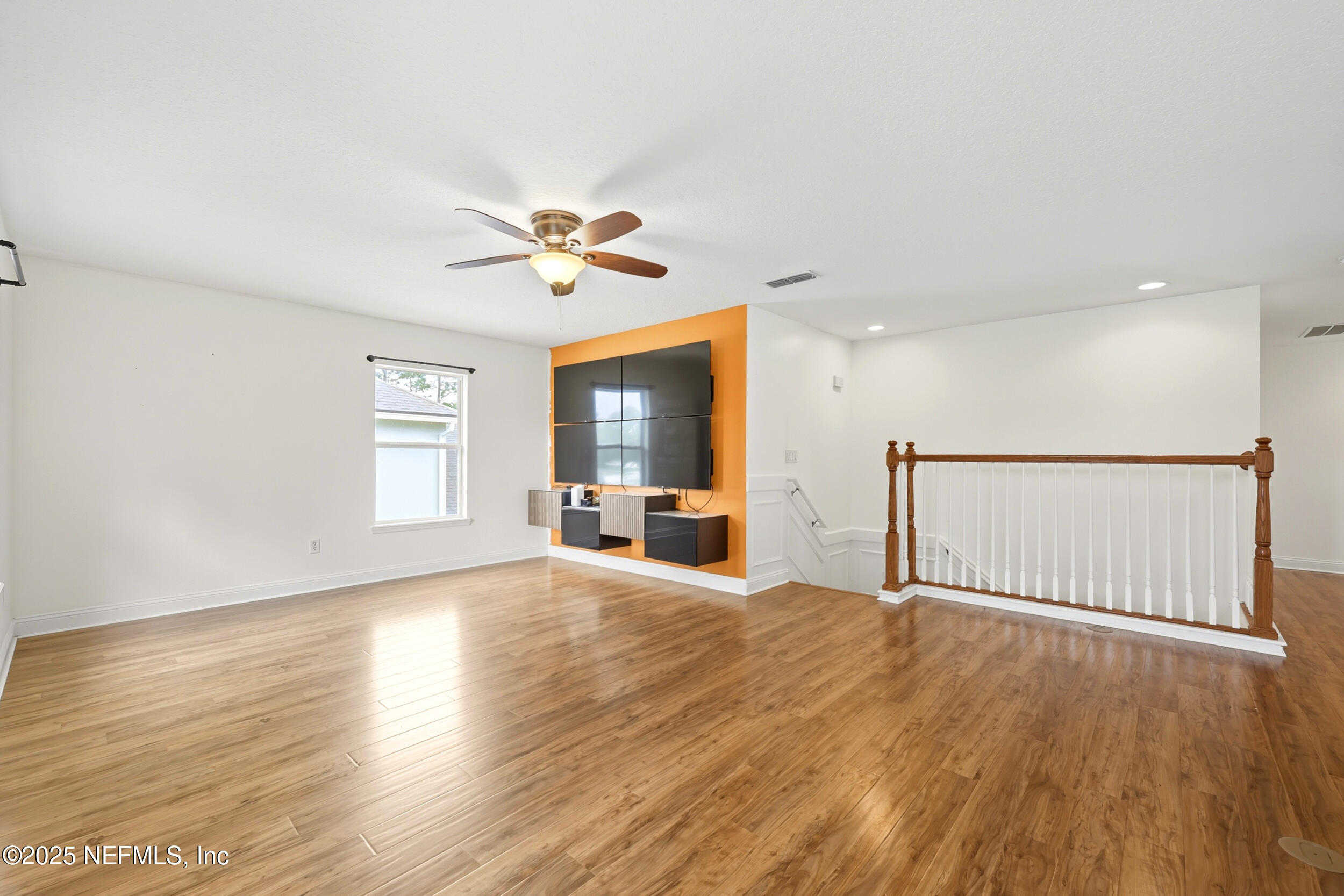 105 Castlegate Lane St. Johns, FL 32259 - Photo 23 of 45 a view of an empty room with a window and wooden floor