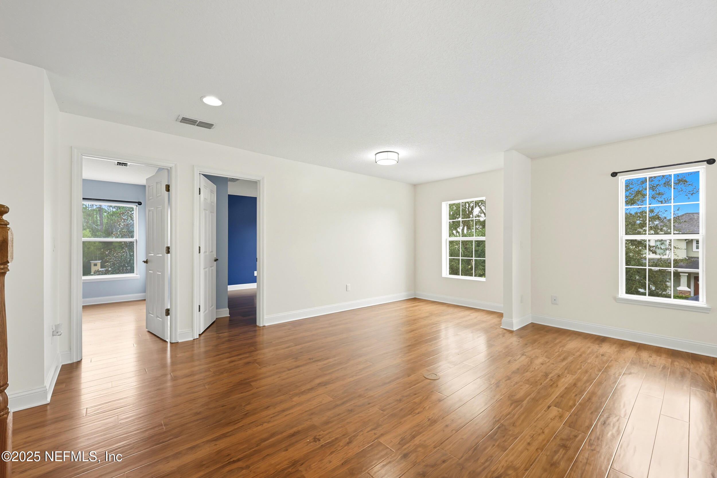 105 Castlegate Lane St. Johns, FL 32259 - Photo 24 of 45 an empty room with wooden floor and windows