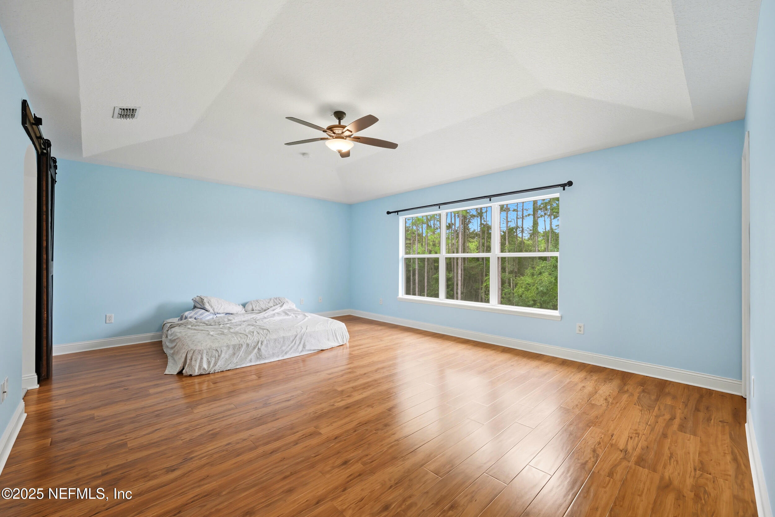 105 Castlegate Lane St. Johns, FL 32259 - Photo 34 of 45 a view of an empty room with wooden floor and a window