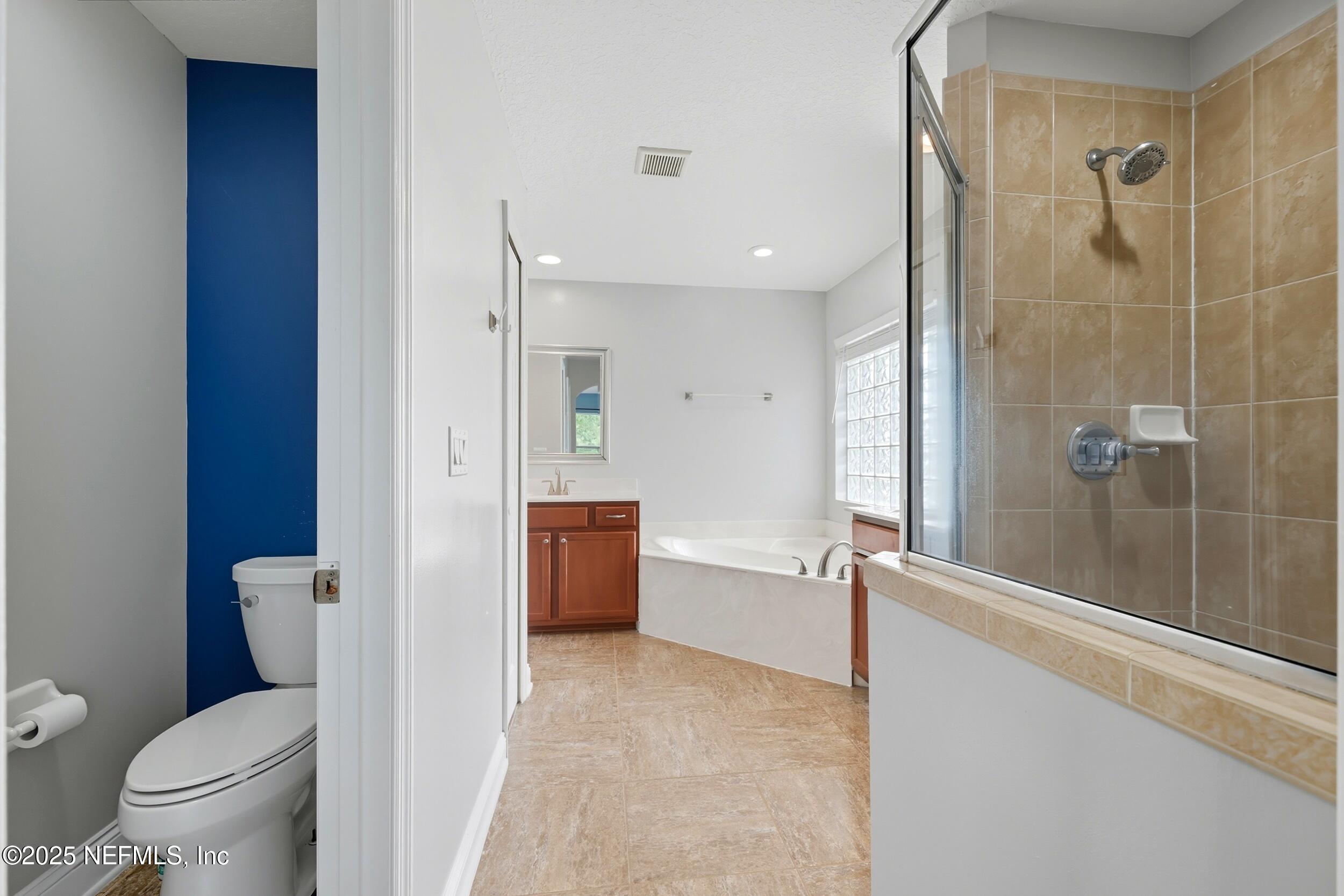 105 Castlegate Lane St. Johns, FL 32259 - Photo 35 of 45 a bathroom with a granite countertop sink toilet and shower
