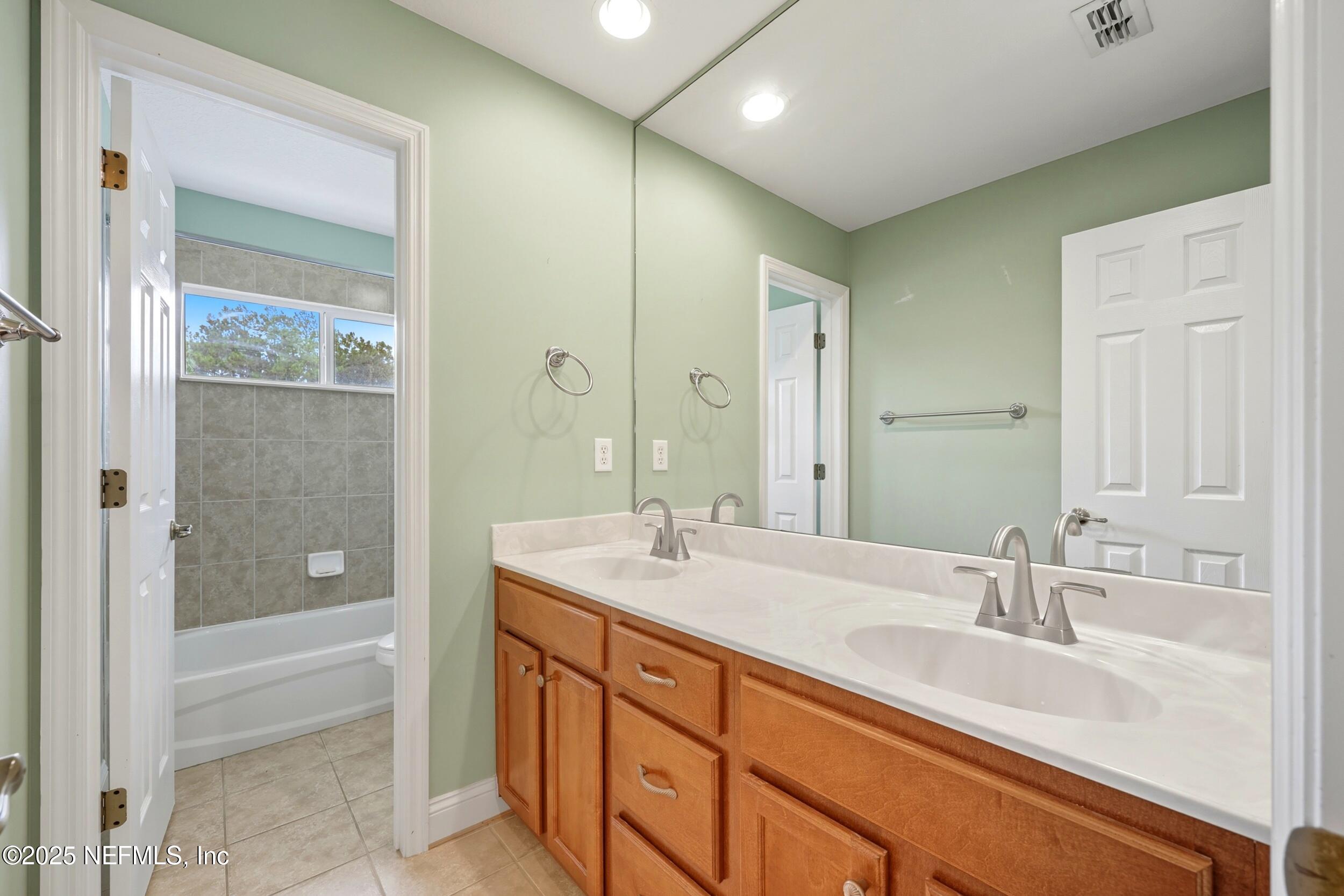 105 Castlegate Lane St. Johns, FL 32259 - Photo 36 of 45 a bathroom with a granite countertop sink shower and a mirror