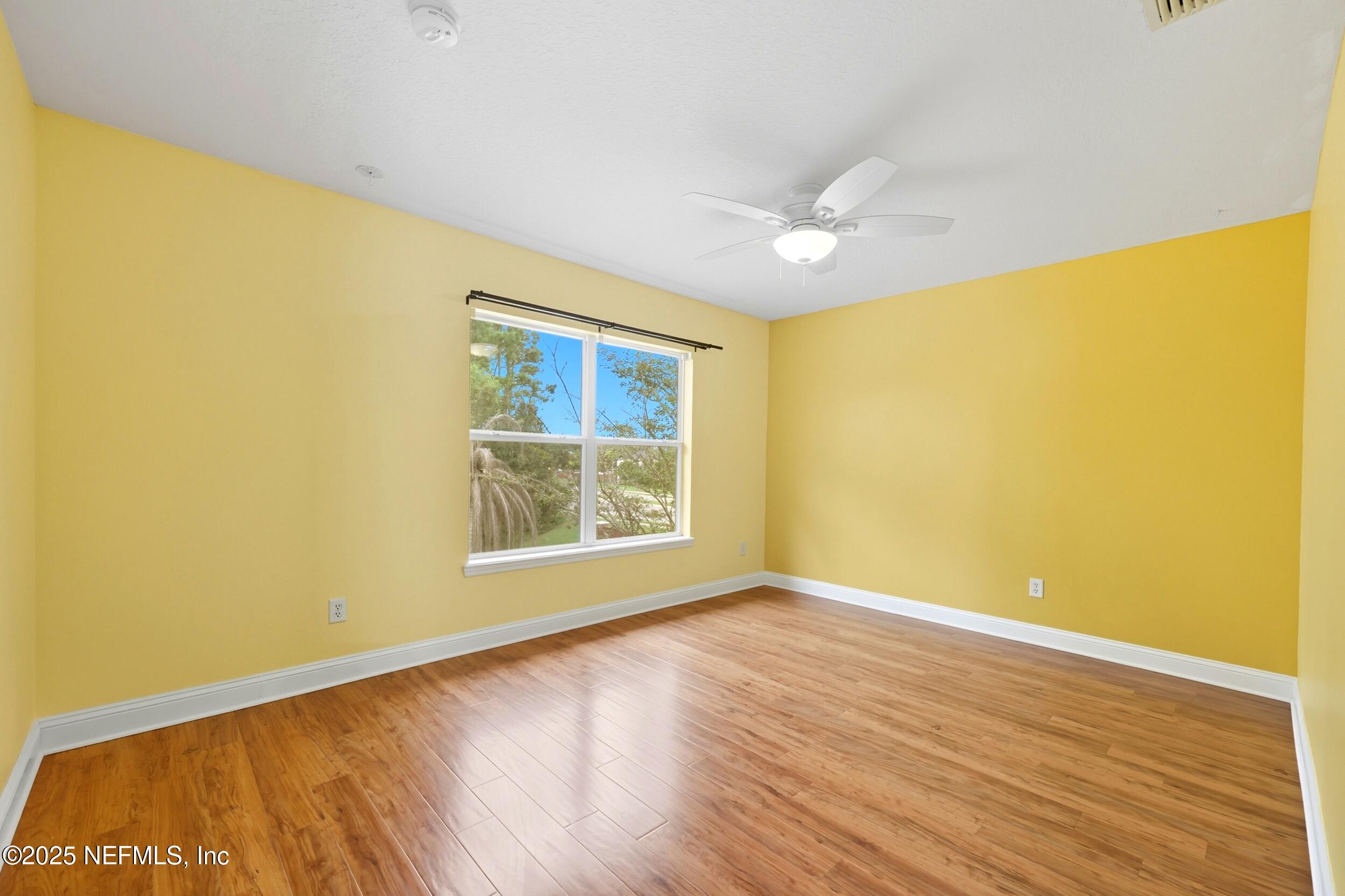 105 Castlegate Lane St. Johns, FL 32259 - Photo 37 of 45 a view of an empty room with wooden floor and a window