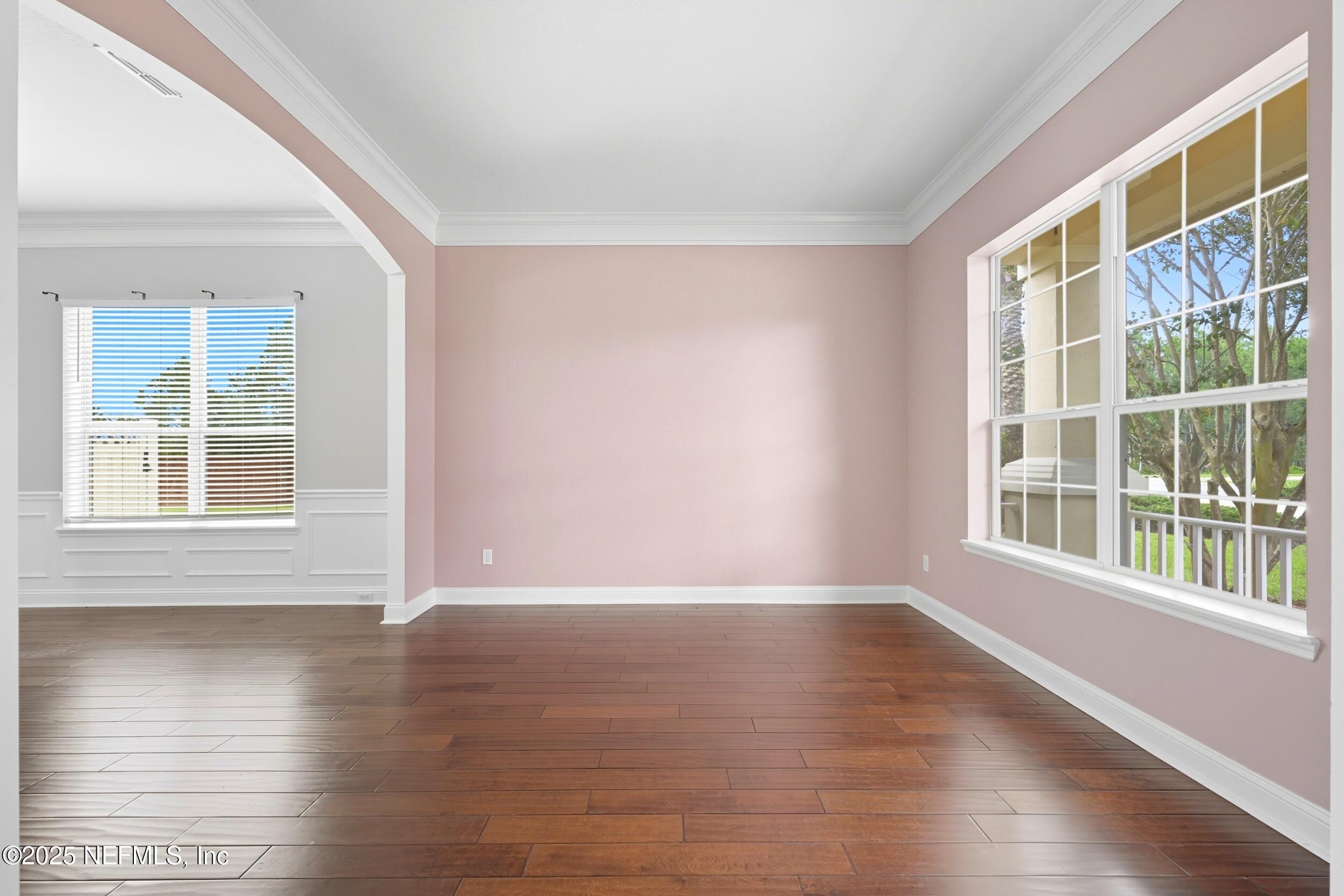 105 Castlegate Lane St. Johns, FL 32259 - Photo 6 of 45 a view of an empty room with wooden floor and windows