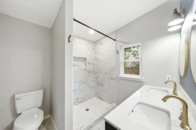 a bathroom with a sink toilet and shower