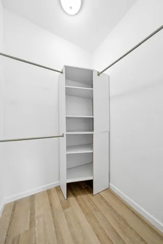 a view of an empty room with a closet