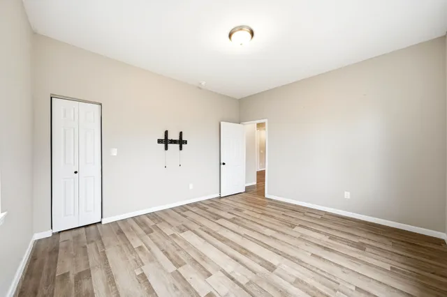 a view of a room with wooden floor