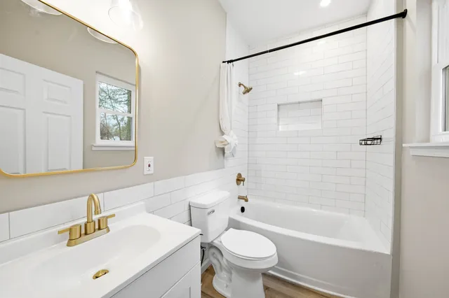 a bathroom with a sink mirror toilet and bathtub