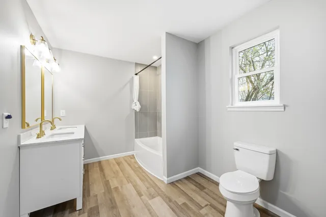 a bathroom with a sink toilet and shower
