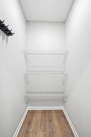 a view of walk in closet with empty racks