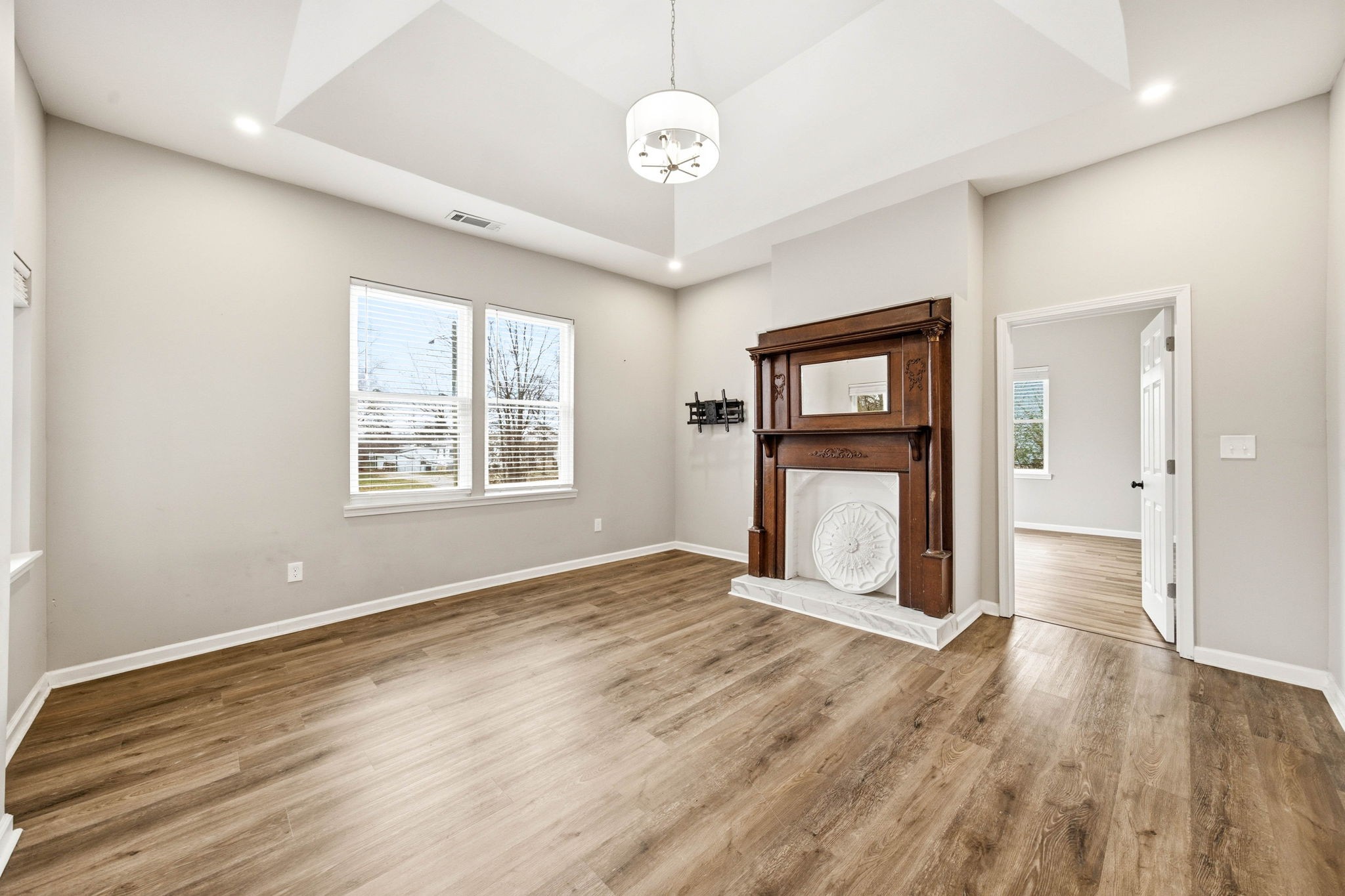 504 North Washington Street Tullahoma, TN 37388 - Photo 5 of 41 a view of an empty room with a window and wooden floor