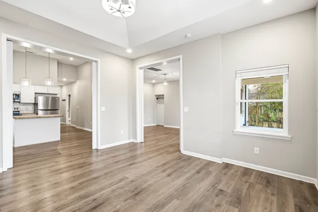 a view of a kitchen with wooden floor and a kitchen