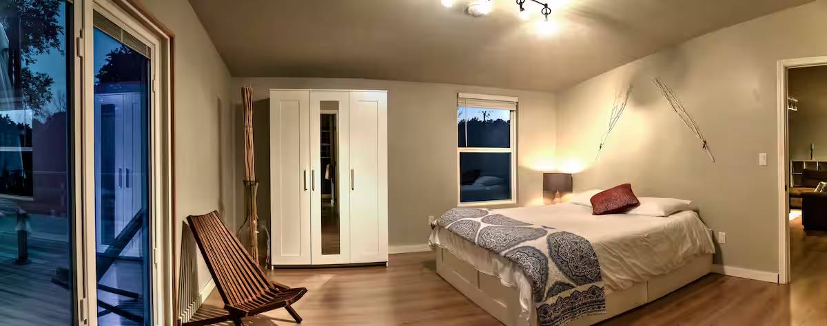 8807 High Valley Road Austin, TX 78737 - Photo 9 of 22 Hardwood flooring extends through this cozy bedroom with direct outdoor access and a generous closet.