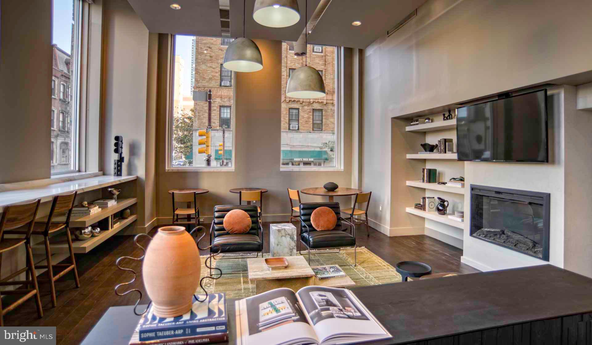2300 Walnut Street, Unit 1B232 Philadelphia, PA 19103 - Photo 17 of 30 a living room with furniture a flat screen tv and a fireplace