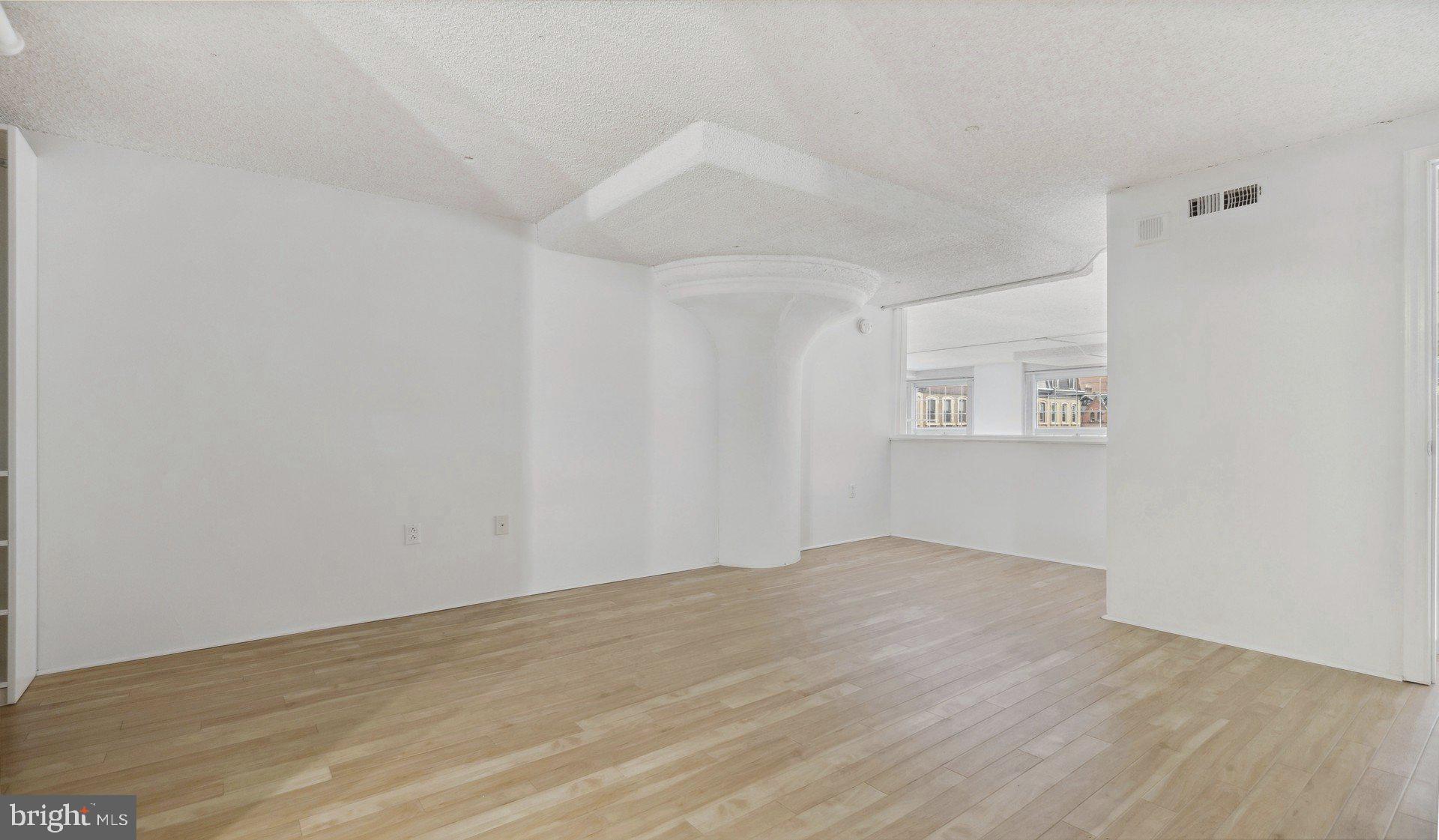 2300 Walnut Street, Unit 1B232 Philadelphia, PA 19103 - Photo 22 of 30 an empty room with wooden floor and windows