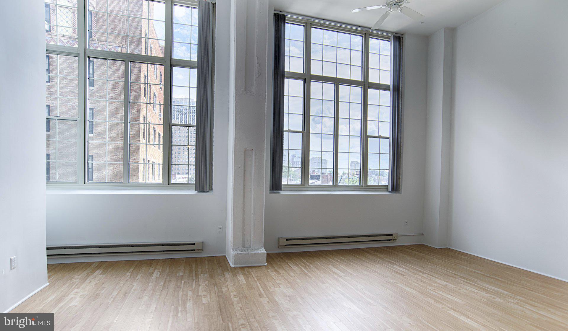2300 Walnut Street, Unit 1B232 Philadelphia, PA 19103 - Photo 25 of 30 a view of an empty room with wooden floor and a window