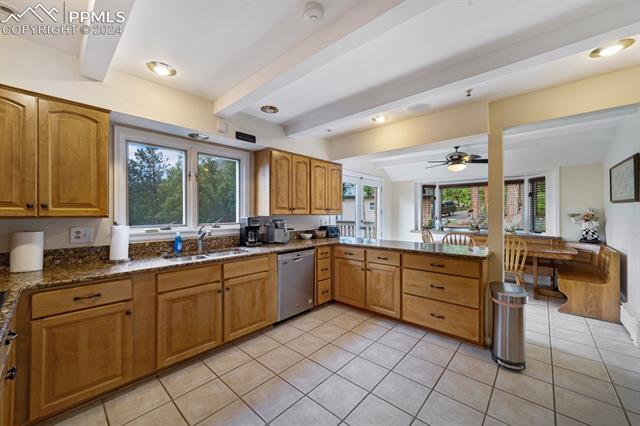 13 Pine Road Colorado Springs, CO 80906 - Photo 8 of 41 Kitchen with dishwasher, sink, plenty of natural light, and ceiling fan