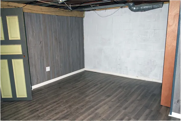 a view of a room with wooden floor