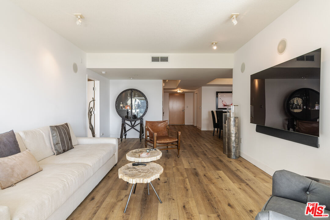 13600 Marina Pointe Drive, Unit 901 Marina del Rey, CA 90292 - Photo 7 of 41 a living room with furniture and a fireplace